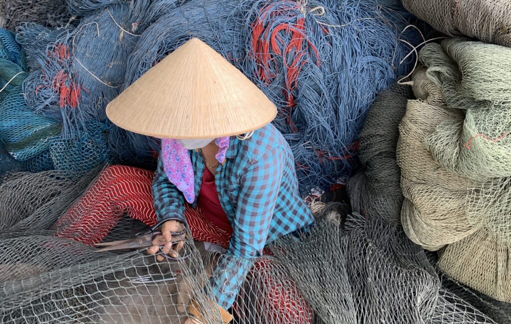 Banner-Repairing-fishing-nets-in-coastal-Vietnam.-Image-courtesy-of-3SIP2C-project-scaled.jpeg