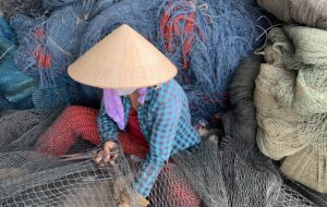 Banner-Repairing-fishing-nets-in-coastal-Vietnam.-Image-courtesy-of-3SIP2C-project-scaled.jpeg